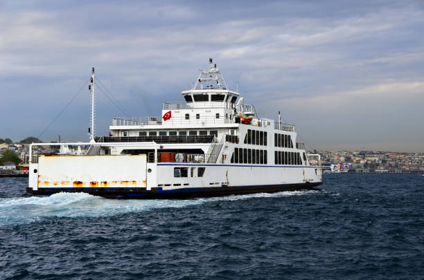 Ferry Ferry goes to European side from Asian side of Istanbul under clear sky, full of vehicles.  This is the alternative way for drivers instead of using bridges. Also Galata Tower is visible as background. galata tower photos stock pictures, royalty-free photos & images