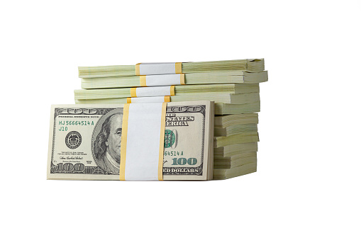 A large stack of hundred-dollar cash bills on a wooden background. Mockup. Including clipping path.