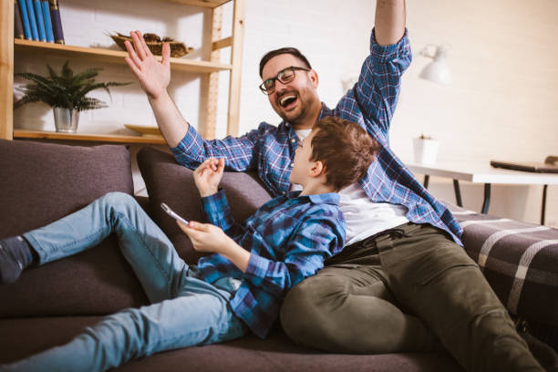 istock Father and cute little son using phone 1289886566