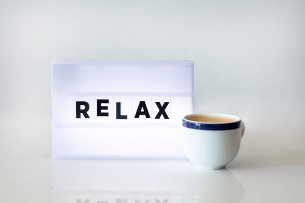 istock RELAX concepts with text on light box AND CUP OF COFFEE in home office. 1289886802