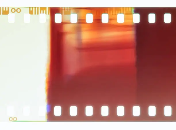 Close-up of 35mm negative photographic film, showing an abstract pattern caused by a light leak.