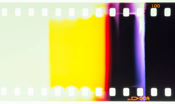 Light leaks on photographic film Close-up of the start of a roll of processed 35mm photographic transparency film, showing where the film has been exposed to light. film reel photos stock pictures, royalty-free photos & images
