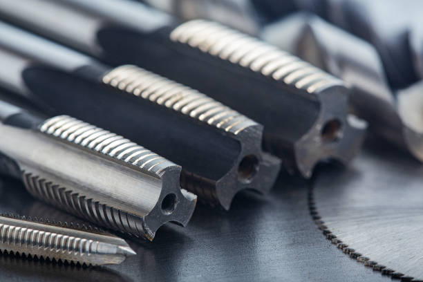 istock set of different drill bits,thread tap and mill cutters with caliper ruler on steel plate background. Locksmithing deal. 1289888202