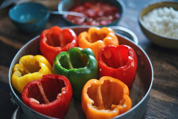 istock Preparing Stuffed Bell Peppers with Ground Meat in Tomato Sauce 1289889265