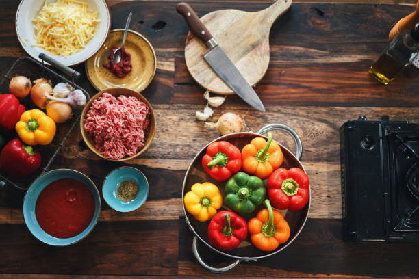Preparing Stuffed Bell Peppers with Ground Meat in Tomato Sauce