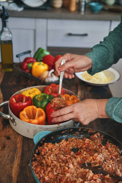 istock Preparing Stuffed Bell Peppers with Ground Meat in Tomato Sauce 1289890111