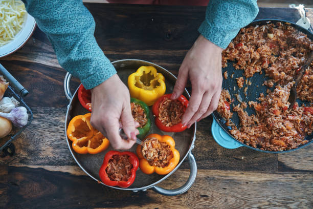 istock Preparing Stuffed Bell Peppers with Ground Meat in Tomato Sauce 1289890290
