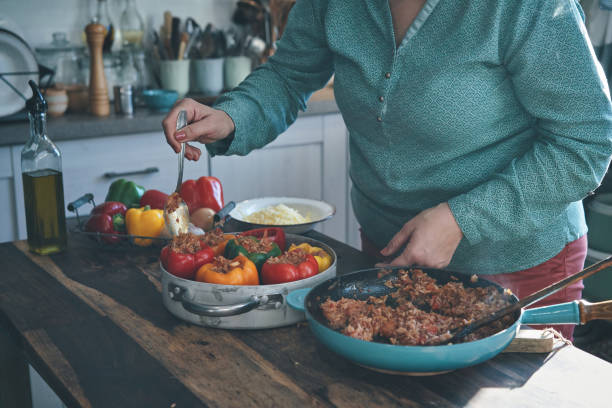 istock Preparing Stuffed Bell Peppers with Ground Meat in Tomato Sauce 1289890292