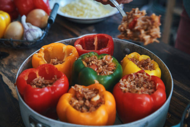preparazione di peperoni ripieni con carne macinata in salsa di pomodoro - tomato sauce domestic kitchen meat cheese foto e immagini stock