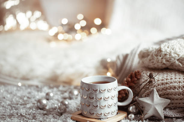 istock Cozy winter background with a beautiful cup, decor details and bokeh copy space. 1289890534