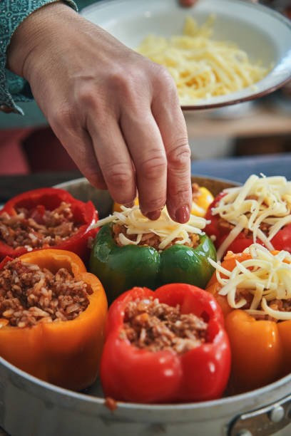 istock Preparing Stuffed Bell Peppers with Ground Meat in Tomato Sauce 1289890540