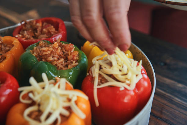 istock Preparing Stuffed Bell Peppers with Ground Meat in Tomato Sauce 1289890542