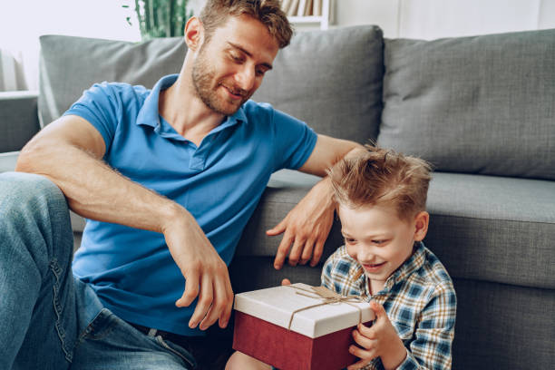 istock Father gives a present in box to his little son 1289891868