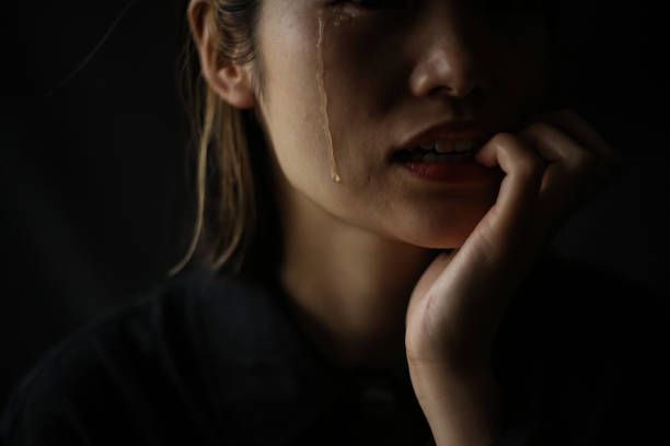 istock A woman who bites her nails while shedding tears 1289893214