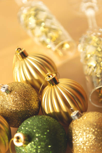 istock green and gold  Christmas baubles on a beige background 1289894617