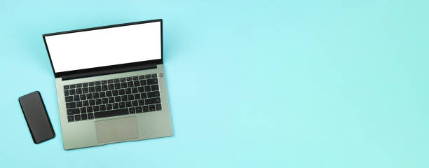 istock A banner with a smartphone and a white mockup on a laptop screen on a blue background top view 1289895890