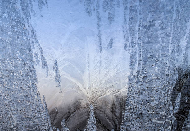 istock Beautiful ice flowers at a window on a very cold winter day. 1289899468