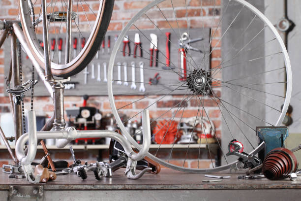 vintage bicycle in garage workshop on the workbench with tools, diy and repair concept