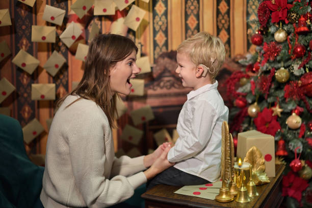 A Boy with Cochlear Implants play with Christmas Bell with his Mother