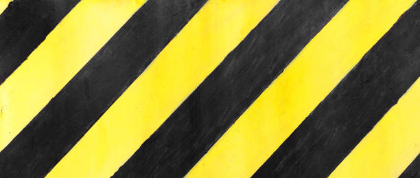 istock Safety stripes on construction site, Black and yellow Under construction sign over a grunge texture, top view 1289901847