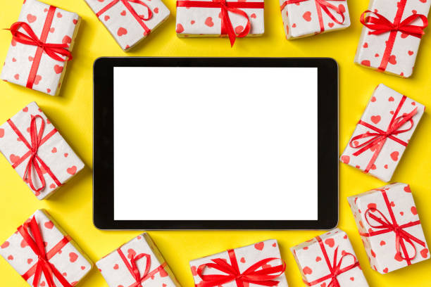 istock Top view of digital tablet surrounded with gift boxes on colorful background. Saint Valentine's day 1289901888