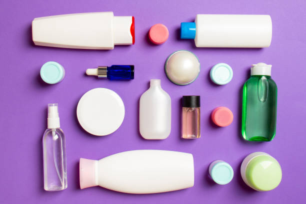 istock Close-up set of diffrent sized bottles and jars for cosmetic products on colored backgound. Face and body care concept with copy space 1289901925