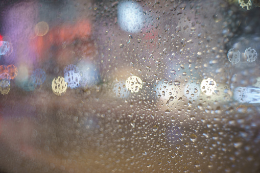 Urban landscape of Shibuya, Tokyo on a rainy night.\nA colorful nightscape of Tokyo seen through a window pane on a rainy night.\nThe glass is covered with raindrops.\nCar headlights and neon lights are blurred. Beautiful bokeh.\nTaken in Shibuya, Tokyo.