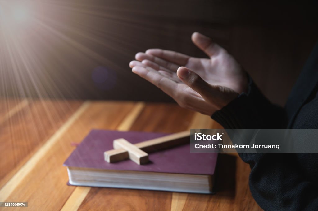 Women pray to God with the Bible and the cross  with morning. Woman Pray for god blessing to wishing have a better life. Christian life crisis prayer to god. Religion Stock Photo