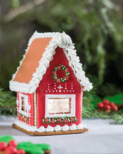 istock Beautiful red gingerbread house on grey background, selective focus 1289906190