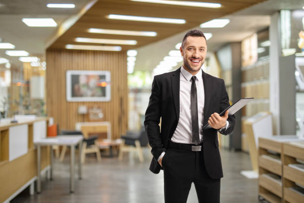 istock Salesman holding a clipboard inside a shop 1289908719