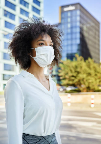 istock Woman  in protective face mask on the street 1289908918