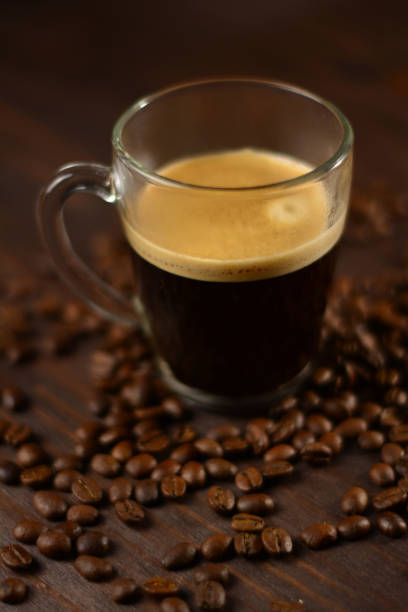 istock Espresso with natural roasted coffee beans on a wooden table 1289909190