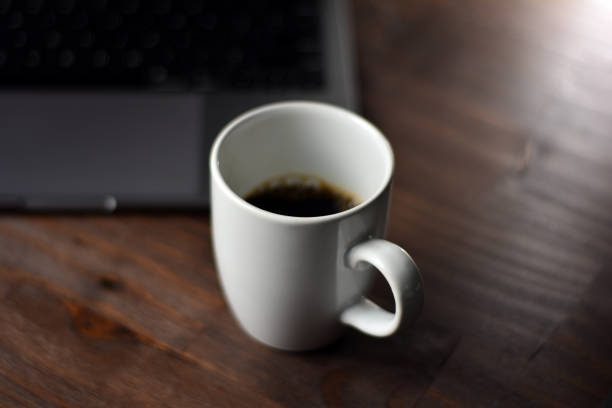 istock Cup of coffee and office items on a wooden table 1289909254