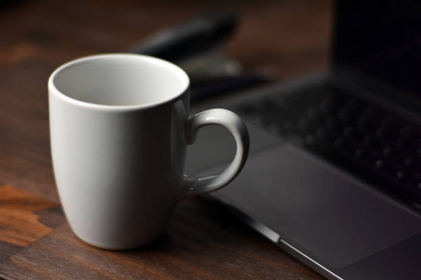 istock Cup of coffee and office items on a wooden table 1289909256