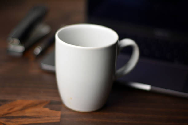 istock Cup of coffee and office items on a wooden table 1289909789