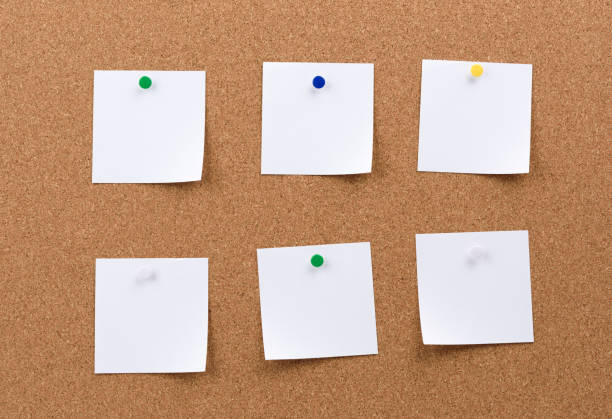 istock white square blank pieces of paper pinned on a cork board 1289910295