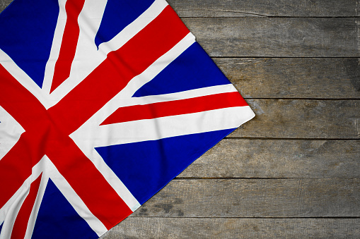Flag of United Kingdom on wooden background, copy space