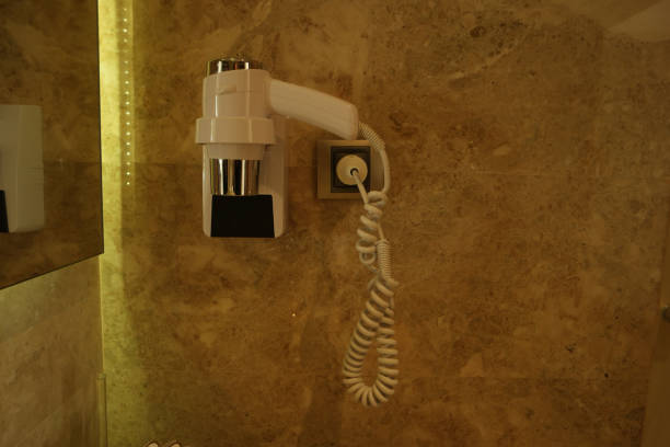 istock Hair dryer on the wall in bathroom 1289911419