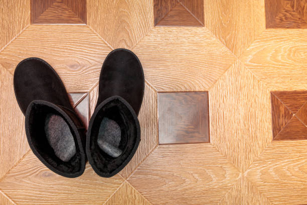 pair of black ugg boots on the floor stock photo