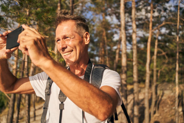 istock Happy man taking picture of marvelous view 1289913008