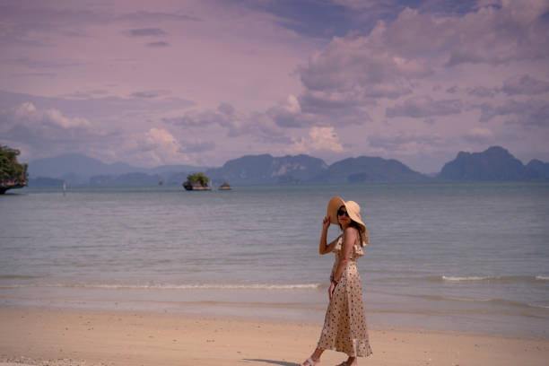 istock beautiful woman on beach 1289915582