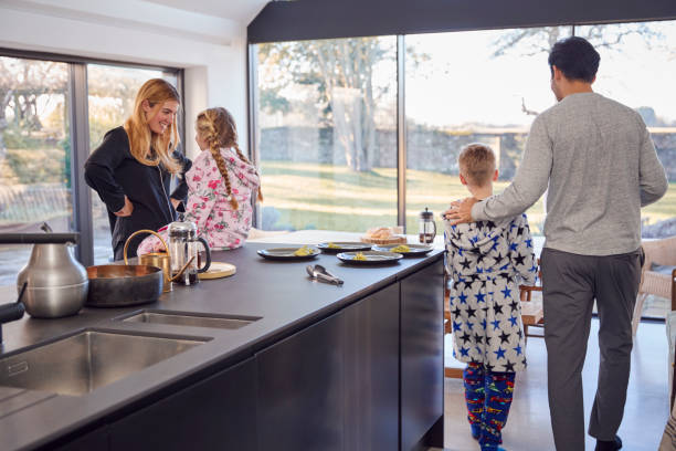 istock Family Preparing Brunch At Home In Modern Kitchen Together 1289915704