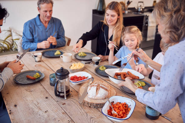 istock Multi-Generation Family Sitting Around Table At Home In Pyjamas Enjoying Brunch Together 1289916554