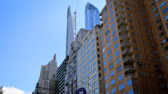 New York, NY, USA - Dec 7, 2020: Contrasting the old and new skyscrapers as viewed from a bus stop on 59th Street in Manhattan