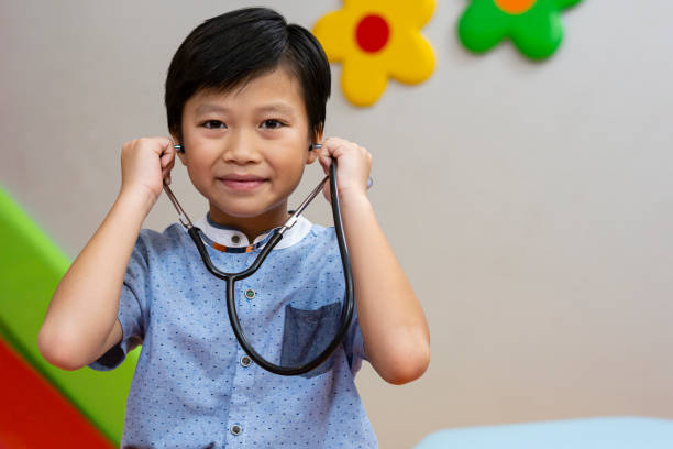 istock A boy wearing a stethoscope with smile. 1289918295