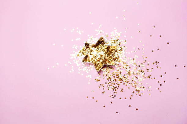 istock Gold star and sequins on a pink background. Blank for baking gingerbread cookies. Flat lay style 1289921246
