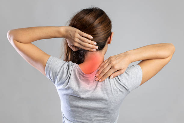 Rear view of young woman with neck pain stock photo