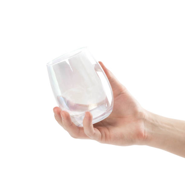 istock Hand holds a glass beaker. Close up. Isolated on white background 1289926737