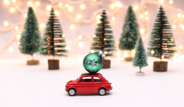 istock Red car carrying a Christmas ball 1289928892