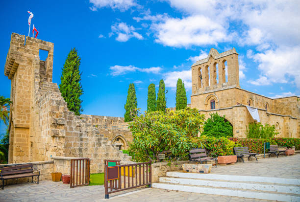 Ruins of Bellapais Abbey monastery stone building in Kyrenia Girne district Ruins of Bellapais Abbey monastery stone building in Kyrenia Girne district, blue sky white clouds background, Northern Cyprus kyrenia photos stock pictures, royalty-free photos & images